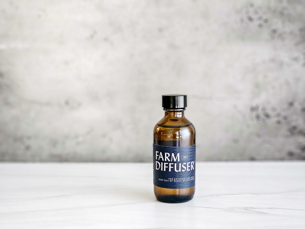 2 ounce amber glass bottle of lavender essential oil on a marble counter