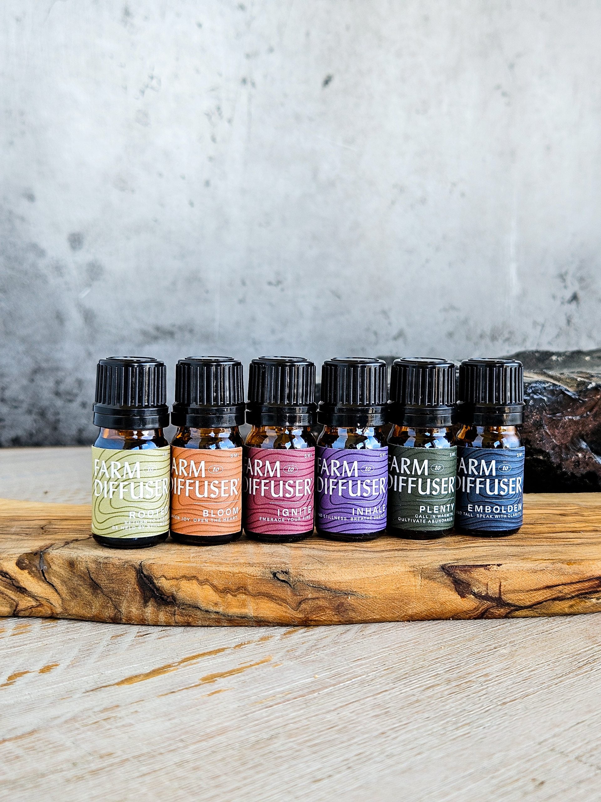 Farm to Diffuser essential oil blends on a wood tray.