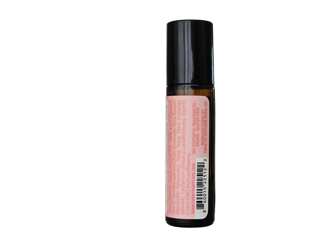 10ml roll-on bottle showing ingredient label: sandalwood, ylang ylang, Peru balsam, cardamom | no synthetic fragrance
