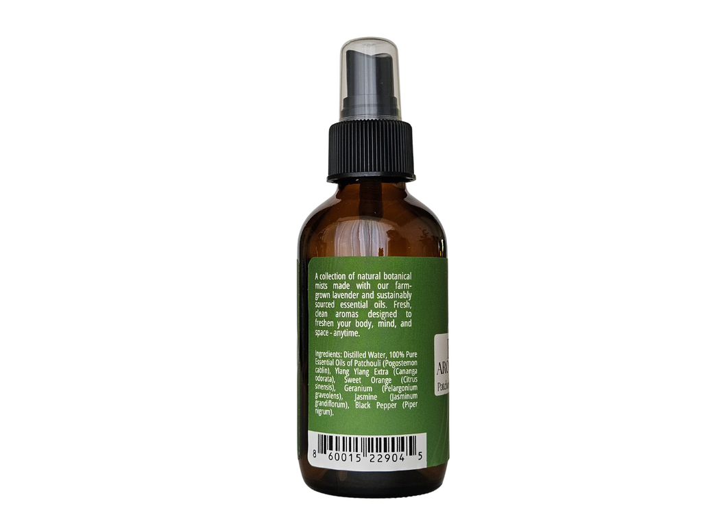 4 fl oz mist bottle showing ingredient label: patchouli, ylang ylang, jasmine absolute, sweet orange, black pepper | no synthetic fragrance