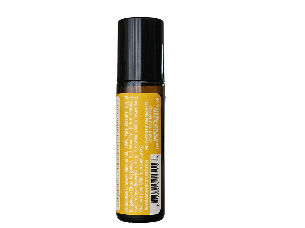10ml roll-on bottle showing ingredient label: frankincense, rosewood, bergamot, mandarin | no synthetic fragrance