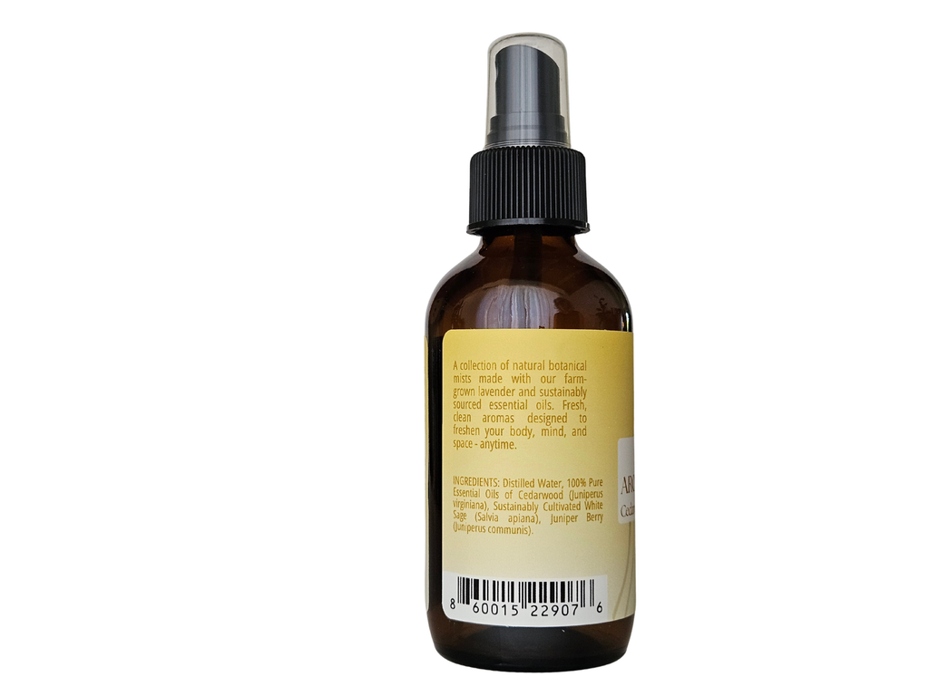 4 fl oz mist bottle showing ingredient label: juniper, cedarwood, white sage | no synthetic fragrance
