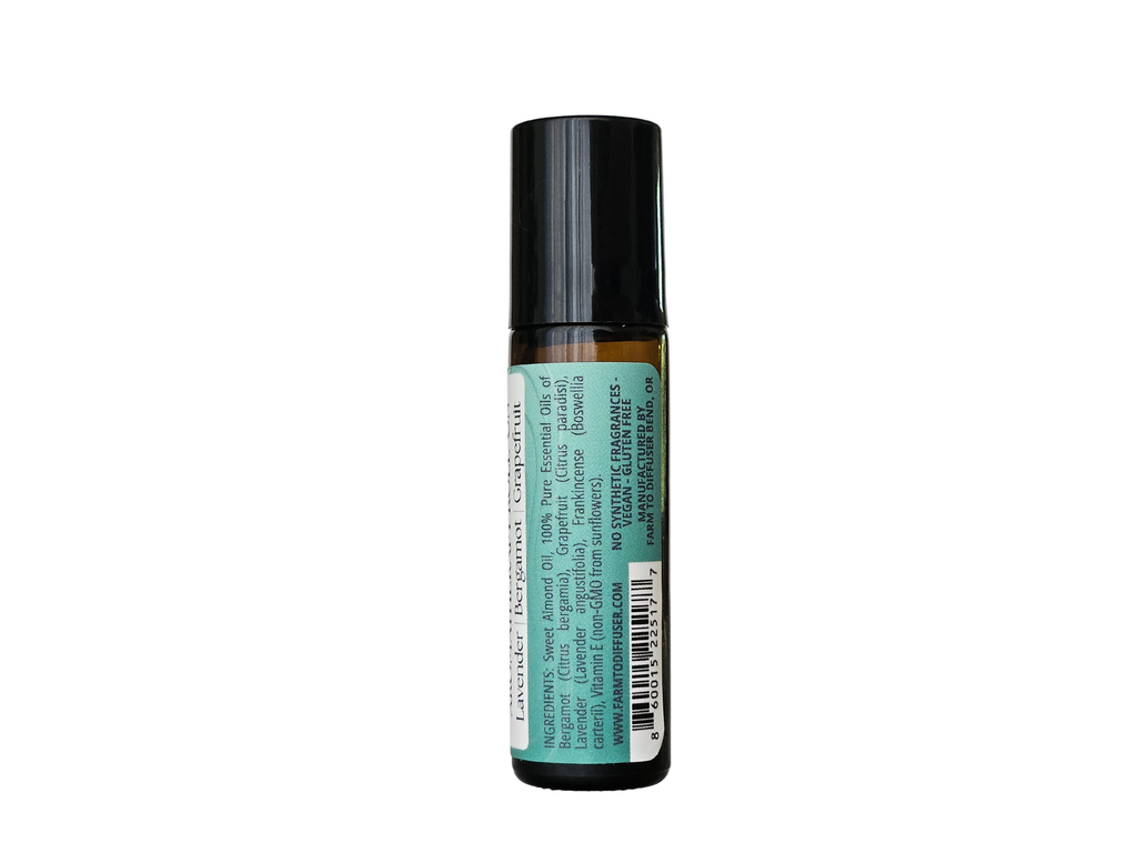 10ml roll-on bottle showing ingredient label: frankincense, lavender, bergamot, grapefruit | no synthetic fragrance