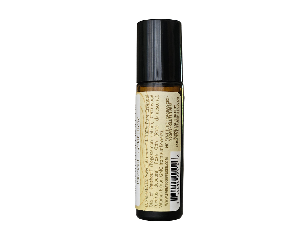 10ml roll-on bottle showing ingredient label: patchouli, Himalayan cedarwood, rose otto | no synthetic fragrance