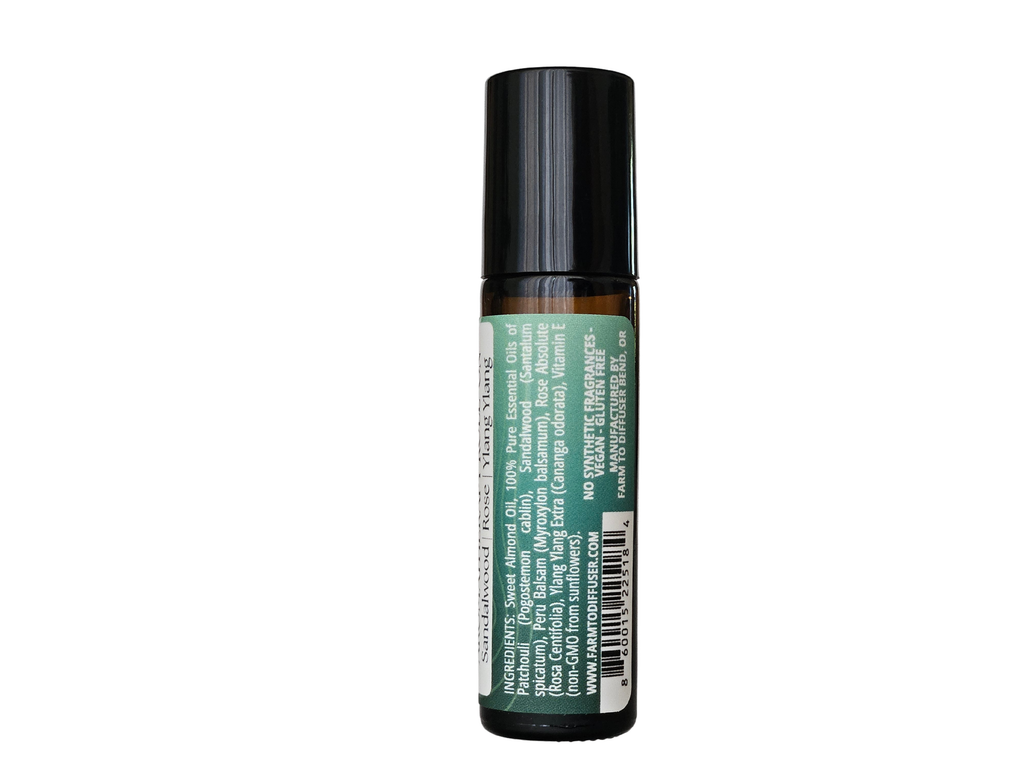 10ml roll-on bottle showing ingredient label: sandalwood, Peru balsam, patchouli, rose absolute, ylang ylang | no synthetic fragrance